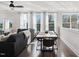 Well-lit living area with a sectional sofa, ceiling fan, and large windows offering plenty of natural light at 10320 Sablewood Dr # 107, Raleigh, NC 27617