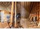 Unfinished attic space showing insulation and wooden beams at 1046 Lawrence Rd, Wake Forest, NC 27587