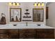 Bathroom boasts double sinks, dark wood cabinets, framed mirrors, and modern fixtures at 1046 Lawrence Rd, Wake Forest, NC 27587