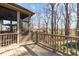 Back deck with seating area leads to screened porch offering expansive views of backyard and mature trees at 1046 Lawrence Rd, Wake Forest, NC 27587
