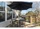 Outdoor deck boasts patio furniture, an umbrella, and a grill, perfect for entertaining at 1046 Lawrence Rd, Wake Forest, NC 27587