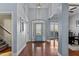 Inviting foyer leading to a dining area, featuring hardwood floors and light blue walls at 1046 Lawrence Rd, Wake Forest, NC 27587
