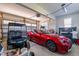 Spacious garage featuring a red luxury car and a blue golf cart at 1046 Lawrence Rd, Wake Forest, NC 27587