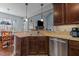 Modern kitchen features granite countertops, stainless steel appliances, dark wood cabinetry, and pendant lighting at 1046 Lawrence Rd, Wake Forest, NC 27587