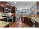 Modern kitchen with stainless steel appliances, granite countertops, and dark wood cabinetry at 1046 Lawrence Rd, Wake Forest, NC 27587