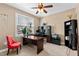 Cozy office with large desk, red chair, ceiling fan, and natural light from a big window at 1046 Lawrence Rd, Wake Forest, NC 27587