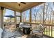 Relaxing screened porch with comfortable seating, a fire pit, and views of the backyard at 1046 Lawrence Rd, Wake Forest, NC 27587