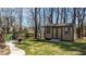 Backyard shed with double doors, windows, and a ramp, offering extra storage at 1046 Lawrence Rd, Wake Forest, NC 27587