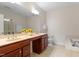 Spacious bathroom featuring dual sinks, a vanity, tile floors, and a separate bathtub and shower at 10511 Rosegate Ct # 203, Raleigh, NC 27617