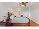 Spacious bedroom featuring hardwood floors, a ceiling fan, and a large bed with wood frame at 10511 Rosegate Ct # 203, Raleigh, NC 27617