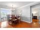 Elegant dining room with hardwood floors and a stylish chandelier, perfect for Gathering gatherings at 10511 Rosegate Ct # 203, Raleigh, NC 27617
