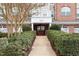 Beautiful building entrance with meticulously maintained landscaping, with inviting entry doors and architectural details at 10511 Rosegate Ct # 203, Raleigh, NC 27617