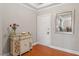 Welcoming entryway features stylish console table, fresh flowers, and attractive mirror, complemented by warm hardwood floors at 10511 Rosegate Ct # 203, Raleigh, NC 27617