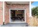 Open garage space featuring a brick exterior, perfect for storage and parking at 10511 Rosegate Ct # 203, Raleigh, NC 27617