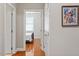 Hallway view leading to a bedroom with a wrought iron bed and window with blinds at 10511 Rosegate Ct # 203, Raleigh, NC 27617