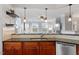 Eat-in kitchen with dark wood cabinetry, tiled backsplash, stainless steel appliances, and breakfast bar at 10511 Rosegate Ct # 203, Raleigh, NC 27617