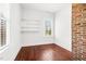 Bright bedroom with hardwood floors, exposed brick and natural light from window at 1100 Reatkin Ln, Graham, NC 27253