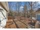 A large wooden deck overlooks the backyard with mature trees. There is ample space for outdoor seating at 1107 Goldendale Dr, Durham, NC 27703