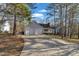 Lovely single-story home with a two-car garage and a concrete driveway surrounded by mature trees at 1107 Goldendale Dr, Durham, NC 27703