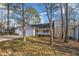 Picture of a one story home with a two-car garage and a quaint front porch, nestled among the trees at 1107 Goldendale Dr, Durham, NC 27703