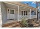 Charming front porch with brick steps, white railings, and a welcoming entrance, complete with address number at 1107 Goldendale Dr, Durham, NC 27703