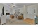 Inviting living room featuring a brick fireplace, plush seating, and ample natural light from large windows at 1107 Goldendale Dr, Durham, NC 27703