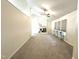 Bright living room with white brick fireplace, ceiling fan, neutral color palette, and large windows at 1107 Goldendale Dr, Durham, NC 27703