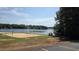 Sandy beach area with volleyball court and kayak racks by the lake at 113 Pony Dr, Louisburg, NC 27549