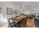 Dining room with hardwood floors, chandelier and open view to kitchen at 113 Pony Dr, Louisburg, NC 27549