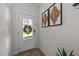 Inviting entryway with a white door, decorative wreath, and elegant wall art at 113 Pony Dr, Louisburg, NC 27549