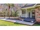 Up close, the home features a charming porch, clean lines, and a 'Welcome' sign at the main entrance at 113 Pony Dr, Louisburg, NC 27549