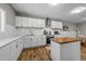 Spacious kitchen with stainless steel appliances, island and tiled backsplash at 113 Pony Dr, Louisburg, NC 27549