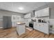 Modern kitchen featuring stainless steel appliances, island, and white cabinetry at 113 Pony Dr, Louisburg, NC 27549