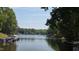 Peaceful lake view with boats docked and lush greenery surrounding at 113 Pony Dr, Louisburg, NC 27549