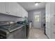 Convenient laundry room is equipped with washer, dryer, and ample storage space at 113 Pony Dr, Louisburg, NC 27549