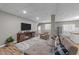 Open concept living room with tv, sofa, and kitchenette at 113 Pony Dr, Louisburg, NC 27549