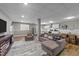 Open-concept living room, adjacent to a kitchen, with neutral tones and comfortable seating at 113 Pony Dr, Louisburg, NC 27549