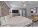 Bright main bedroom with a large bed, neutral colors and sitting area at 113 Pony Dr, Louisburg, NC 27549