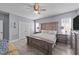 Comfortable main bedroom features stylish furniture, a ceiling fan and large windows at 113 Pony Dr, Louisburg, NC 27549