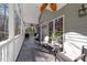 Inviting porch with seating, ceiling fans, and natural light, perfect for relaxing and entertaining outdoors at 113 Pony Dr, Louisburg, NC 27549
