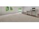 Open-concept living space featuring a seamless transition from carpet to vinyl flooring and abundant natural light at 1152 Solace Way, Rolesville, NC 27571