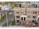 Aerial view of brick townhome with rooftop deck, landscaping, and neighborhood at 117 S Bloodworth St, Raleigh, NC 27601