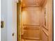 Luxurious home elevator with gold accordion door and custom wood paneling detail at 117 S Bloodworth St, Raleigh, NC 27601