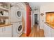 Laundry room with washer, dryer, cabinets, and red sliding door at 117 S Bloodworth St, Raleigh, NC 27601
