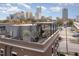 Relaxing rooftop deck with a dining table and grill overlooking the skyline and cityscape at 117 S Bloodworth St, Raleigh, NC 27601