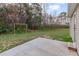 Spacious backyard featuring a concrete patio and a charming swing set amongst mature trees at 11771 Raleigh Rd, Four Oaks, NC 27524