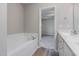 Bathroom showcases a bathtub, modern sink vanity, and tile flooring at 11771 Raleigh Rd, Four Oaks, NC 27524