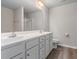 Bathroom boasts double sink vanity, a large mirror, and modern shower at 11771 Raleigh Rd, Four Oaks, NC 27524