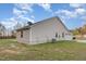 Exterior side view of a light siding home, showcasing the lawn, driveway, and attached garage at 11771 Raleigh Rd, Four Oaks, NC 27524