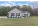 Charming single-story home featuring manicured landscaping, a well-maintained lawn, and a welcoming entrance at 11771 Raleigh Rd, Four Oaks, NC 27524